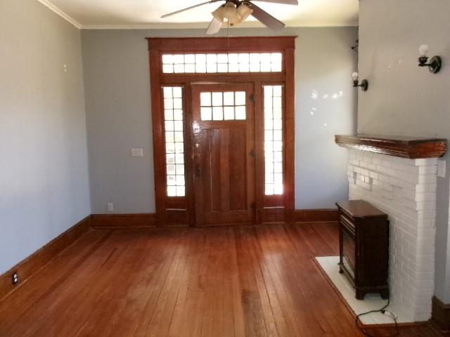 446 Merrick Street Shreveport, LA 71104 - Photo 6 of 16 an empty room with wooden floor and a fireplace