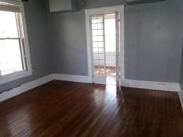 446 Merrick Street Shreveport, LA 71104 - Photo 9 of 16 an empty room with wooden floor and windows