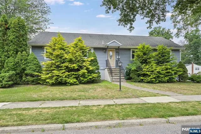 a house that has a tree in front of it