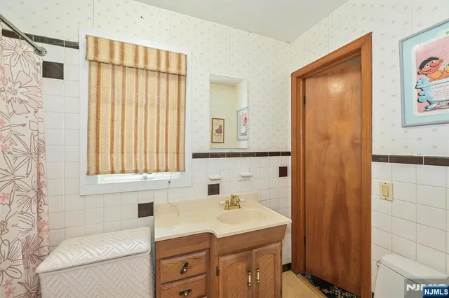 a bathroom with a sink a mirror and a shower