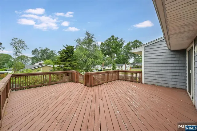 a view of balcony with wooden floor and fence