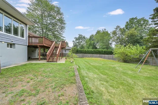 a view of a house with backyard and a slide