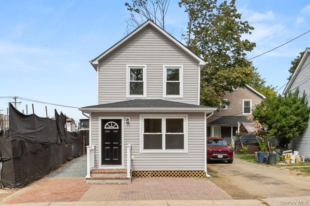 31 Grove Street Hempstead, NY 11550 - Photo 1 of 17 a front view of a house with a garage