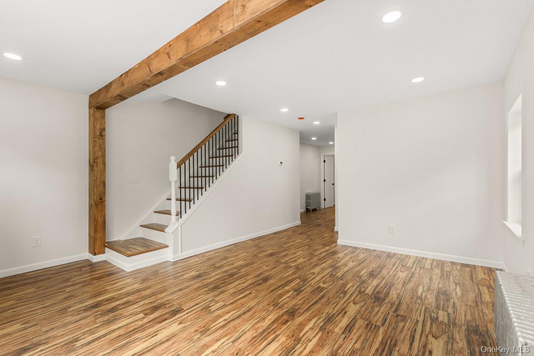 31 Grove Street Hempstead, NY 11550 - Photo 5 of 17 a view of an empty room with wooden floor and entryway