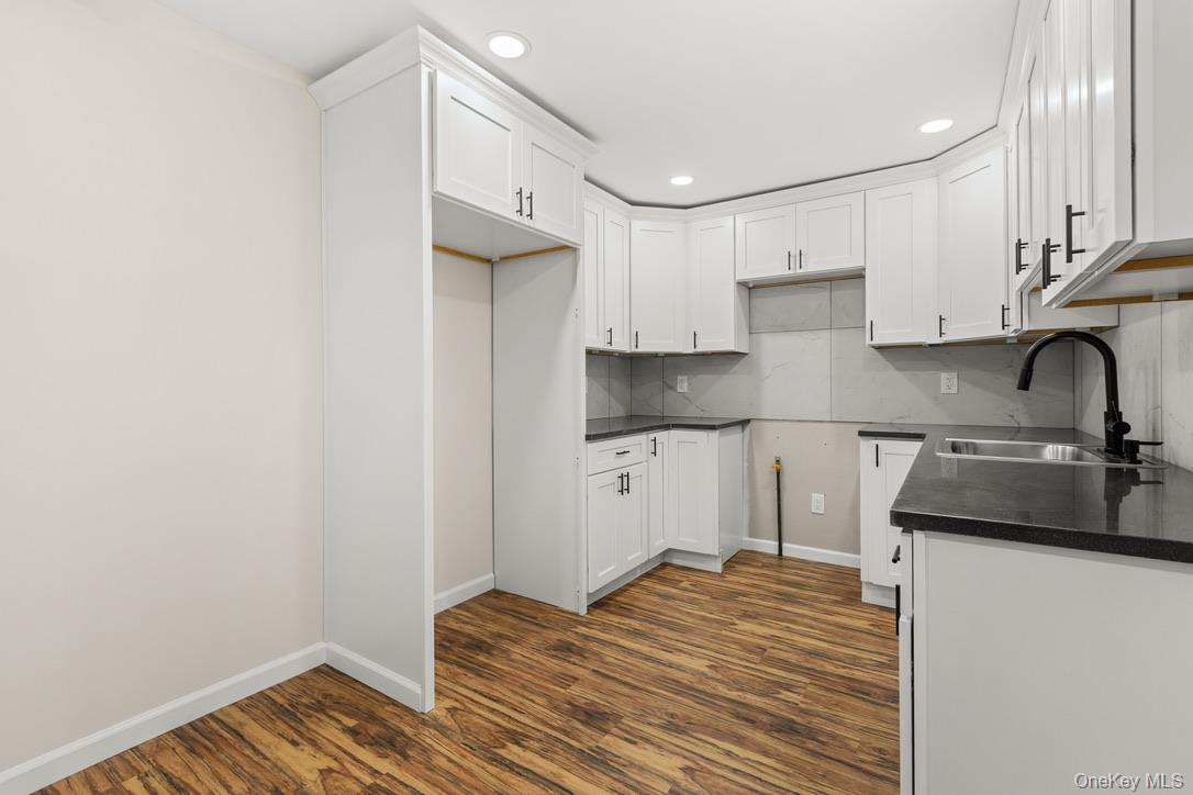 31 Grove Street Hempstead, NY 11550 - Photo 8 of 17 a kitchen with a sink appliances and cabinets
