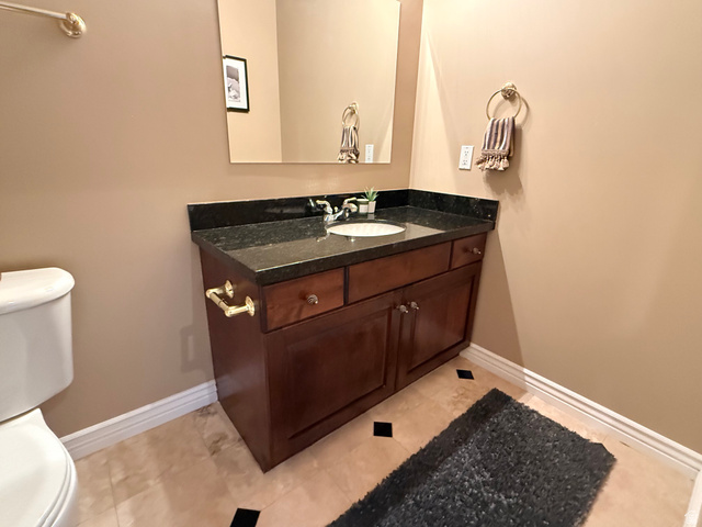 1562 Fairway Ridge Road Draper, UT 84020 - Photo 48 of 60 Wood-finish vanity with a dark countertop and integrated sink