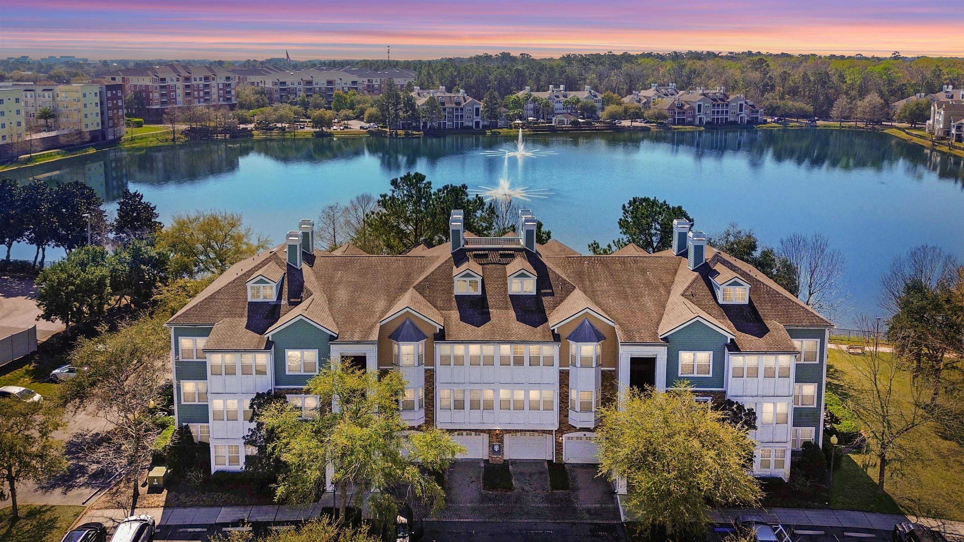 an aerial view of a house with a lake view
