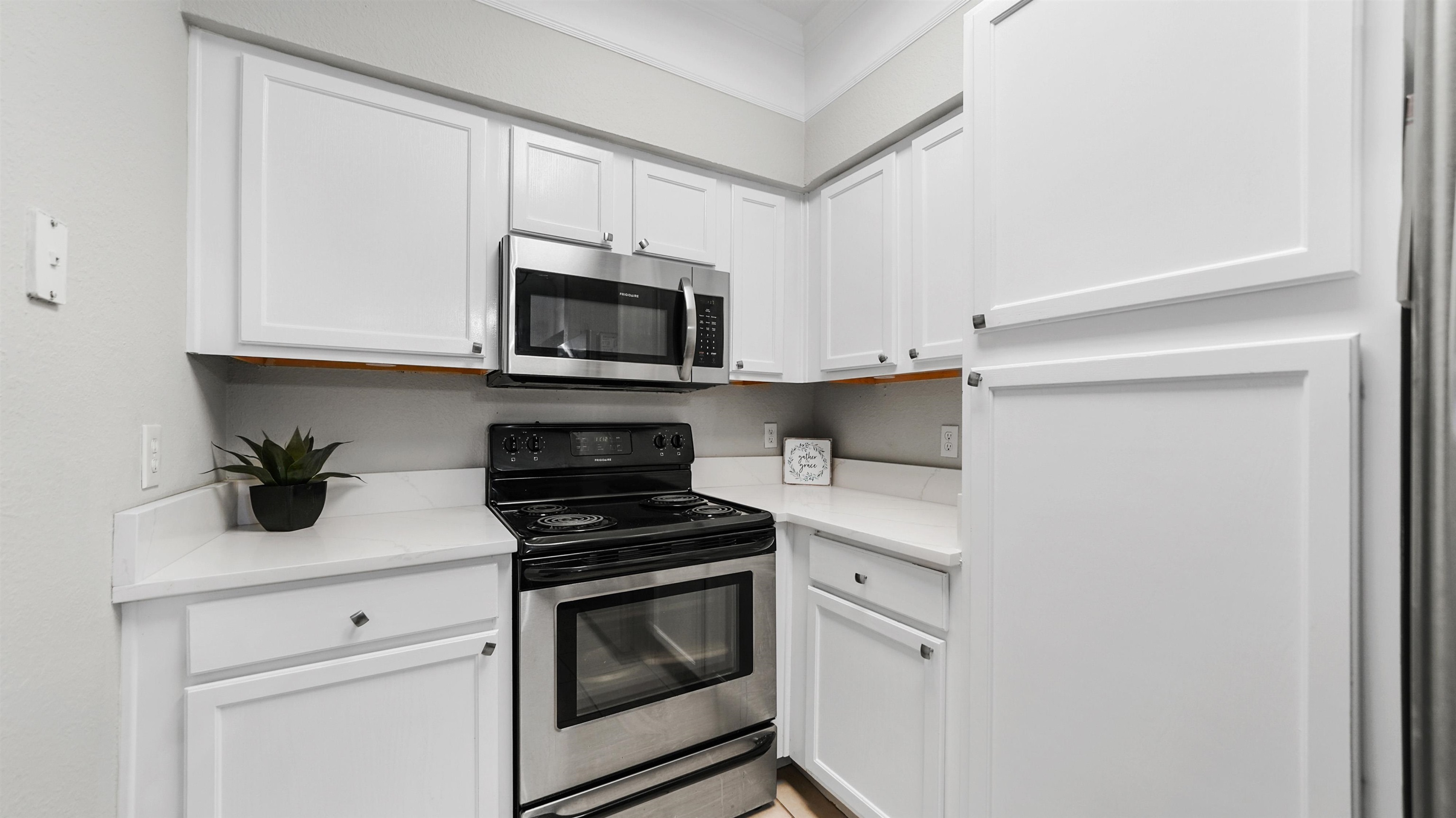 8550 Touchton Road, Unit 625 Jacksonville, FL 32216 - Photo 11 of 47 a kitchen with granite countertop white cabinets stainless steel appliances and a sink