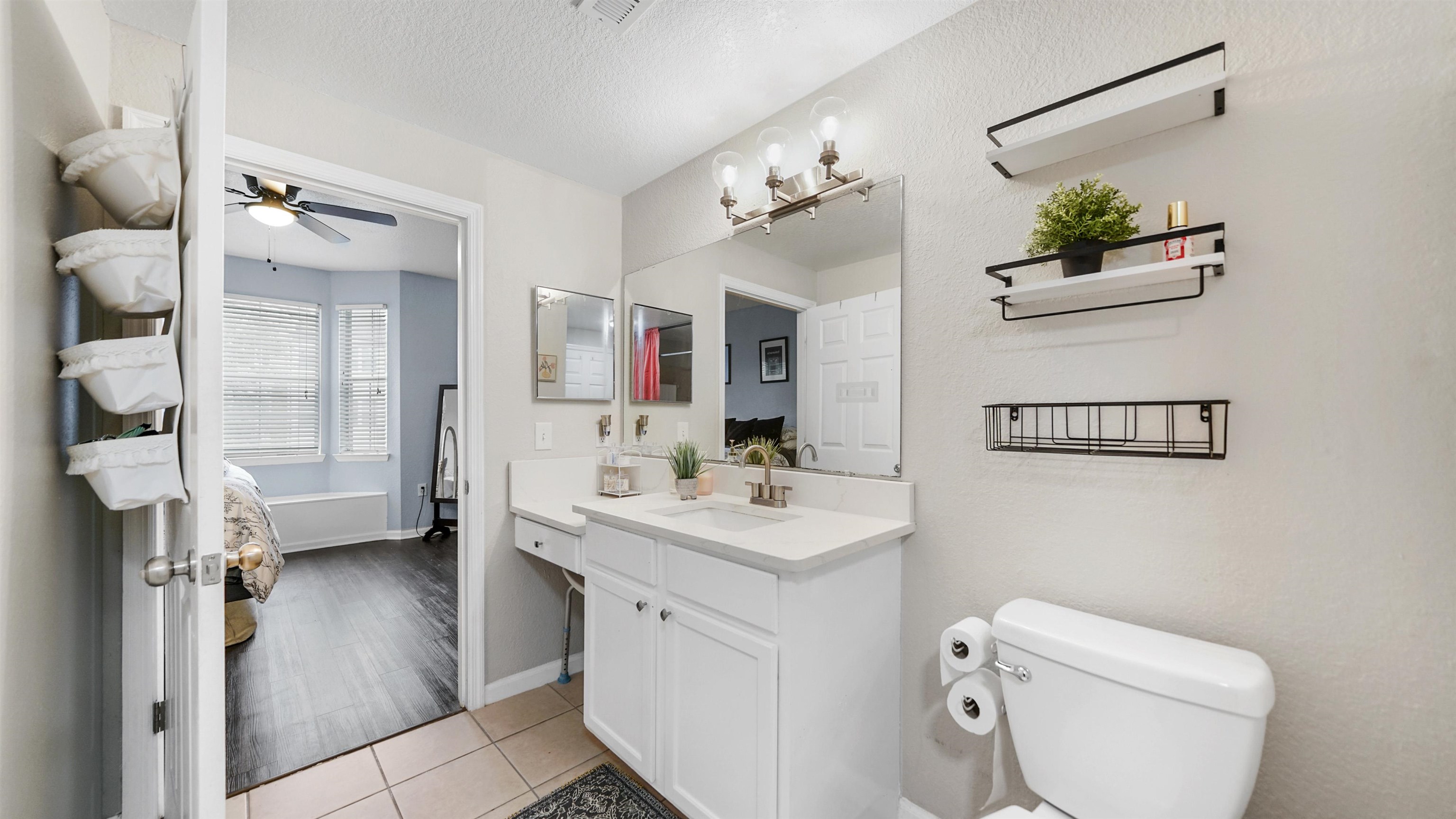 8550 Touchton Road, Unit 625 Jacksonville, FL 32216 - Photo 17 of 47 a bathroom with a toilet sink and mirror