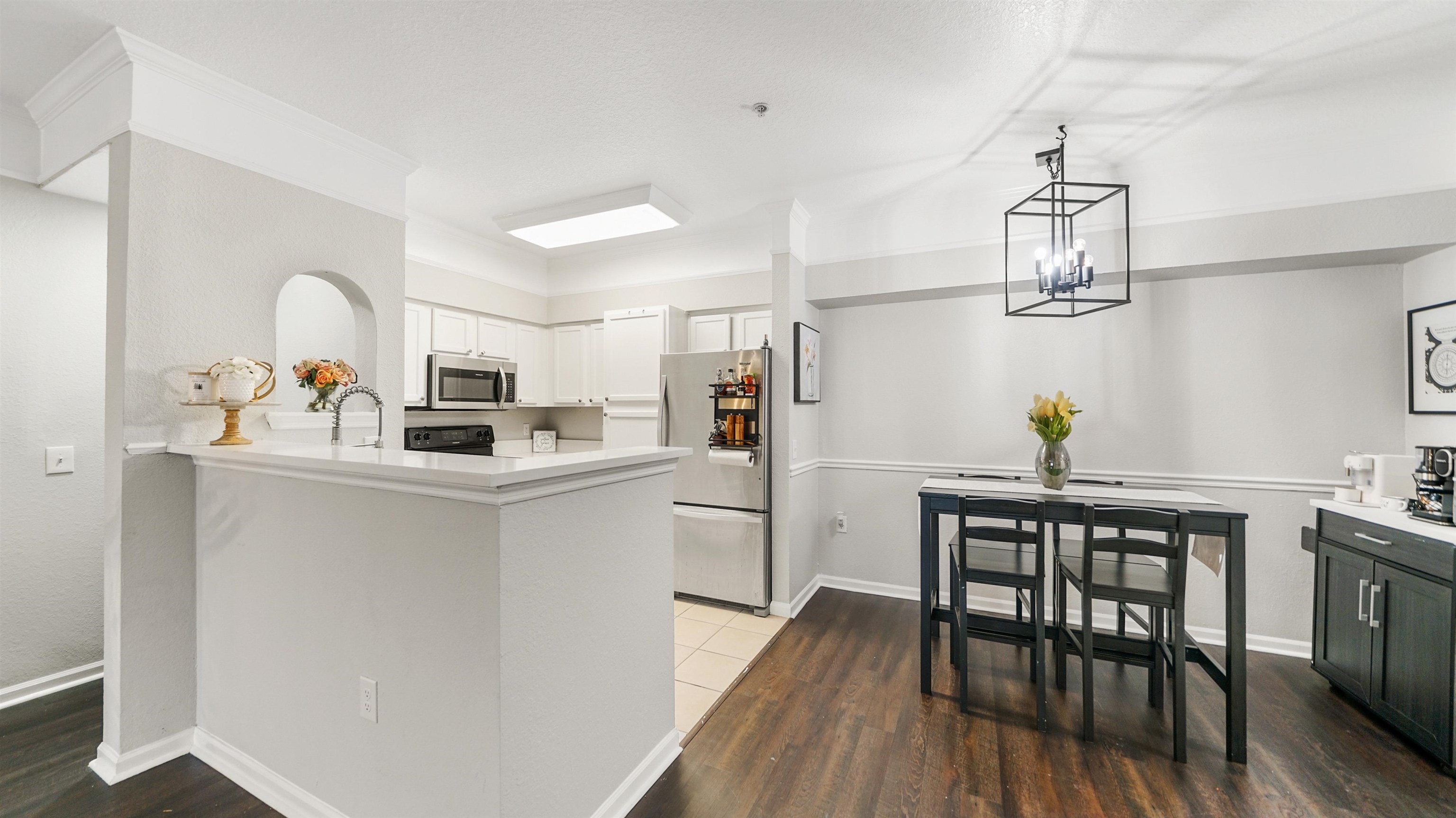 8550 Touchton Road, Unit 625 Jacksonville, FL 32216 - Photo 4 of 47 a kitchen with stainless steel appliances a dining table chairs and wooden floor