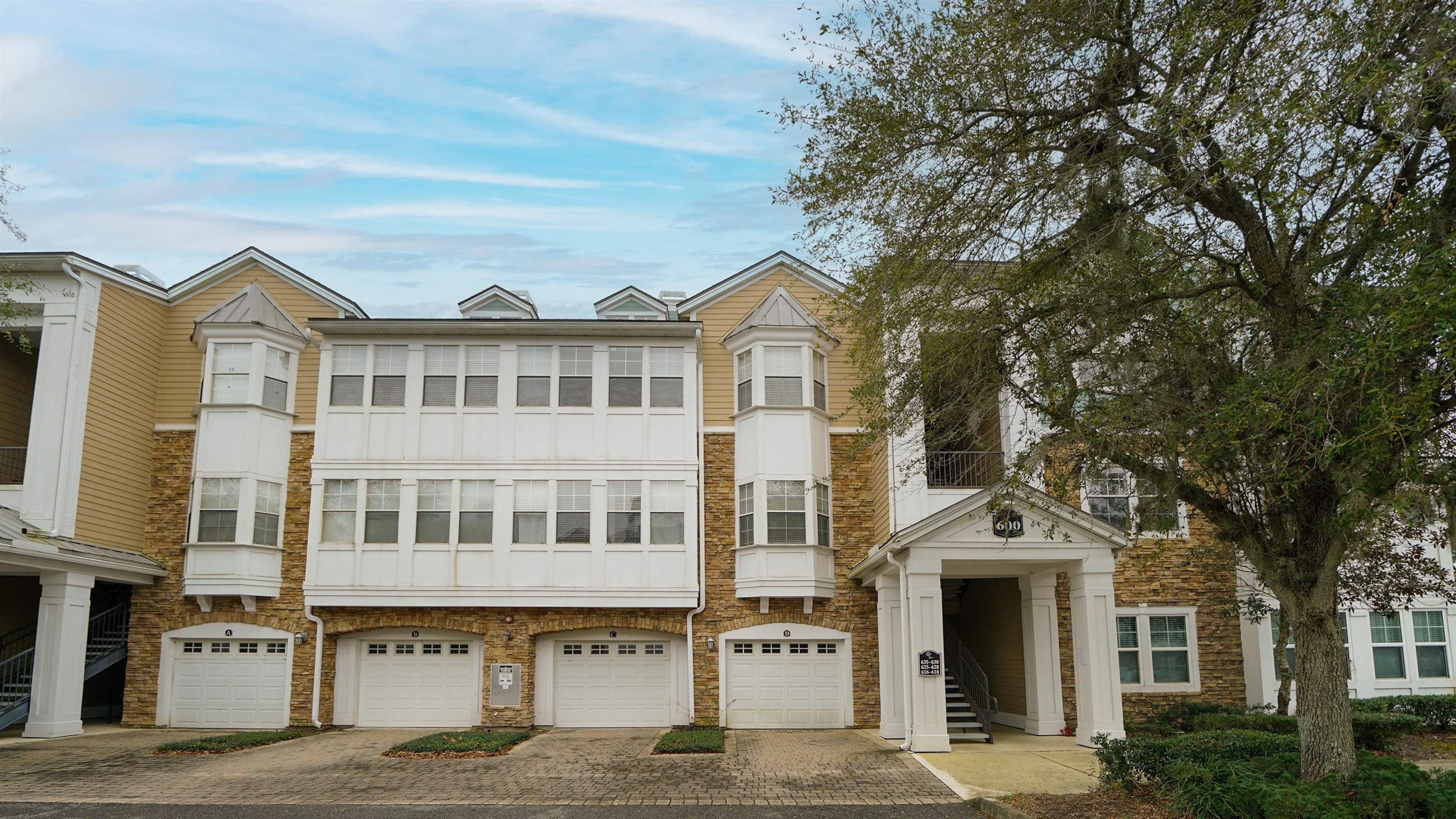 8550 Touchton Road, Unit 625 Jacksonville, FL 32216 - Photo 46 of 47 a front view of a building with a garden and trees