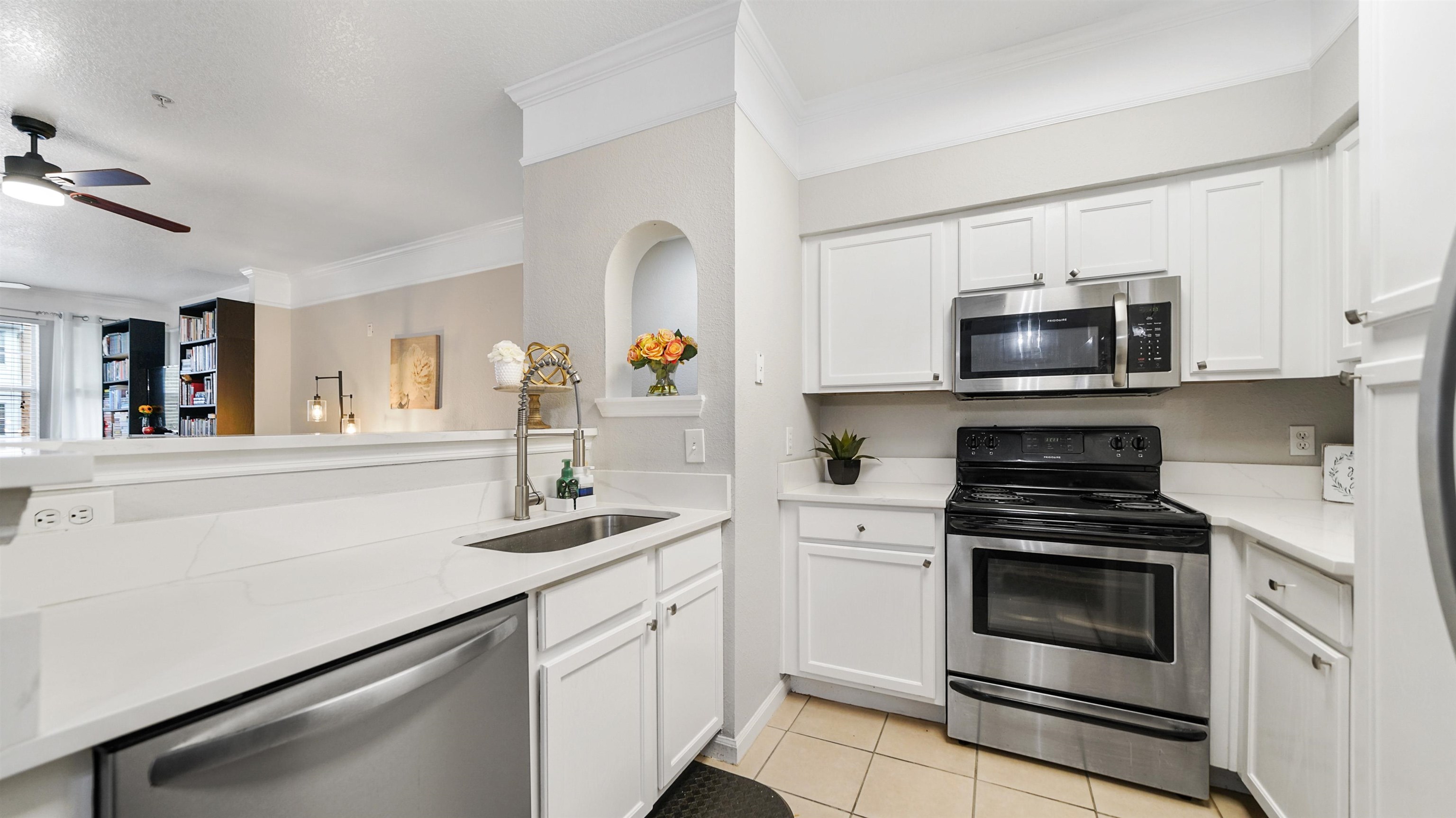 8550 Touchton Road, Unit 625 Jacksonville, FL 32216 - Photo 5 of 47 a kitchen with granite countertop white cabinets and stainless steel appliances