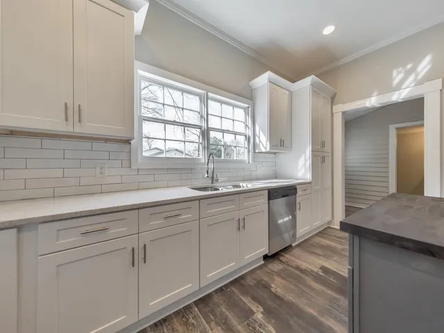 a kitchen with sink cabinets and window