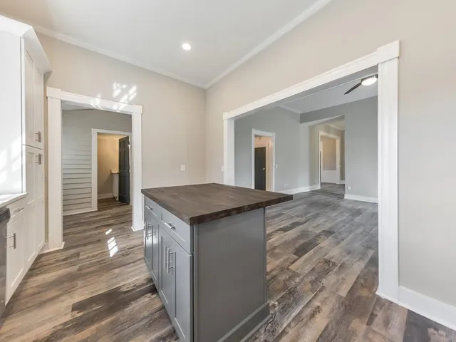 a hallway with a sink and a mirror