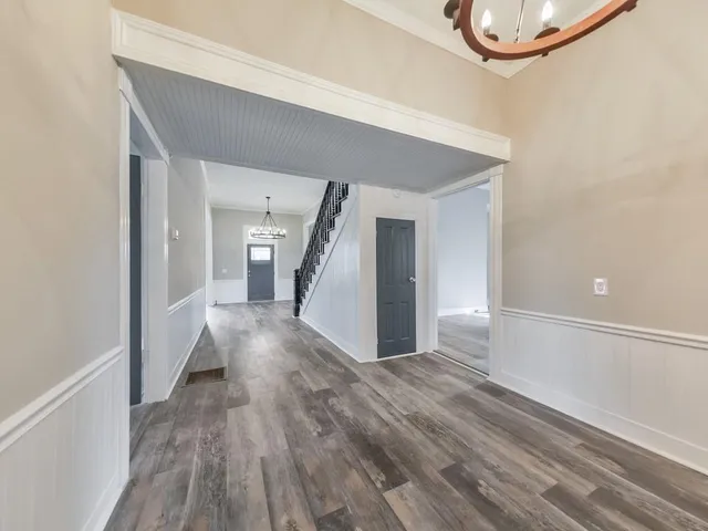 a view of a hallway with wooden floor