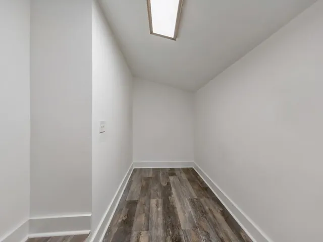 a view of a room with wooden floor and small space