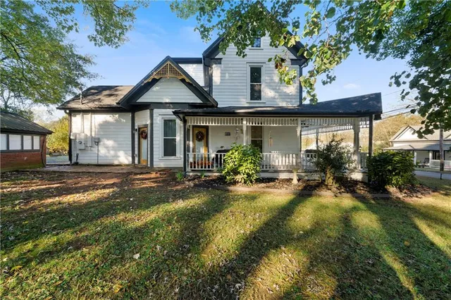 a view of a house with backyard and sitting area