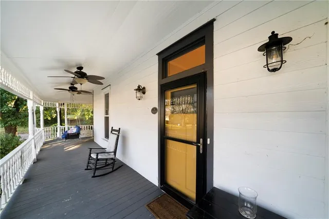 a view of a livingroom with furniture and a floor to ceiling window