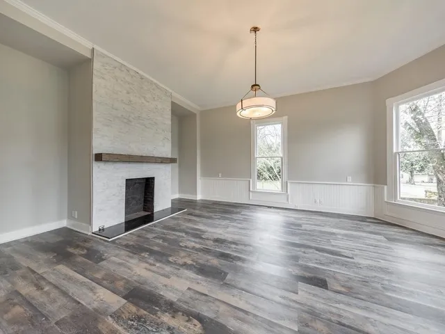 a view of empty room with window and fireplace