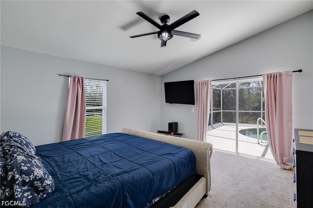 21711 Brixham Run Loop Estero, FL 33928 - Photo 13 of 32 a bedroom with a bed and a flat screen tv