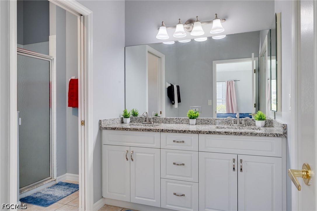 21711 Brixham Run Loop Estero, FL 33928 - Photo 15 of 32 a bathroom with a granite countertop sink and a mirror