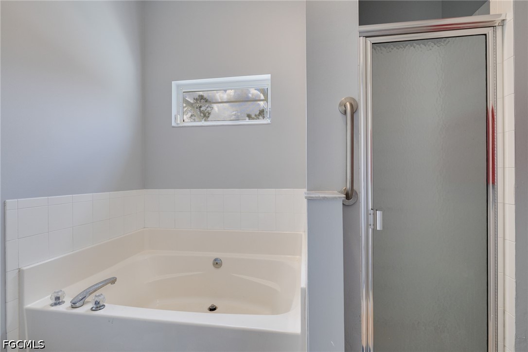 21711 Brixham Run Loop Estero, FL 33928 - Photo 16 of 32 a bathroom with a bathtub