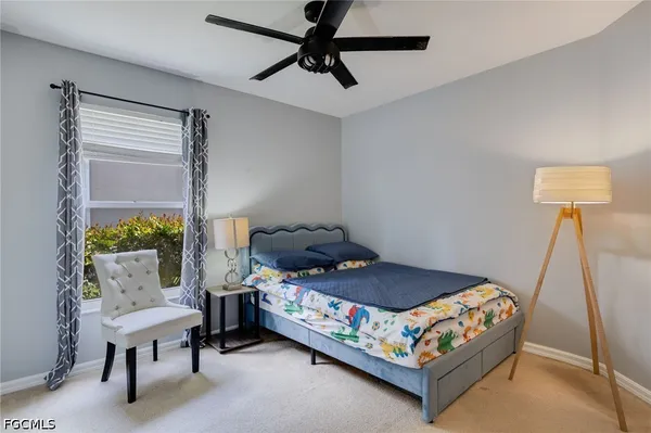 a bedroom with a bed a couch and a window