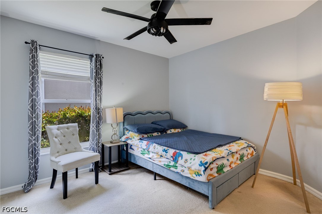 21711 Brixham Run Loop Estero, FL 33928 - Photo 17 of 32 a bedroom with a bed a couch and a window