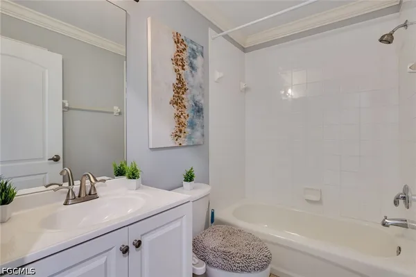 a bathroom with a granite countertop sink a toilet and bathtub