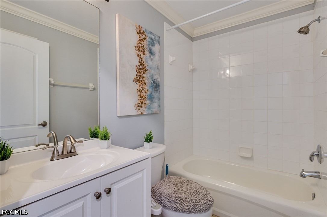 21711 Brixham Run Loop Estero, FL 33928 - Photo 19 of 32 a bathroom with a granite countertop sink a toilet and bathtub