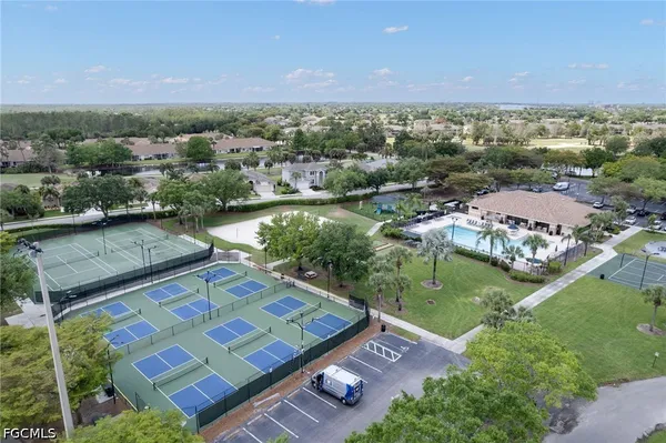 an aerial view of a residential houses with outdoor space and river