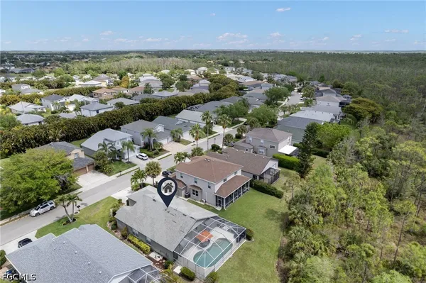 an aerial view of residential houses with outdoor space and river