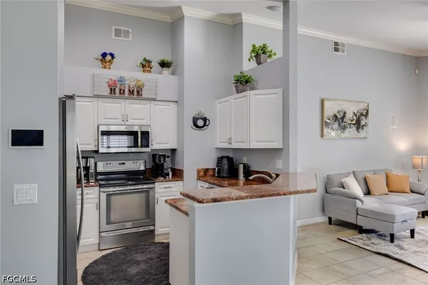 a kitchen with stainless steel appliances a stove a sink and a refrigerator