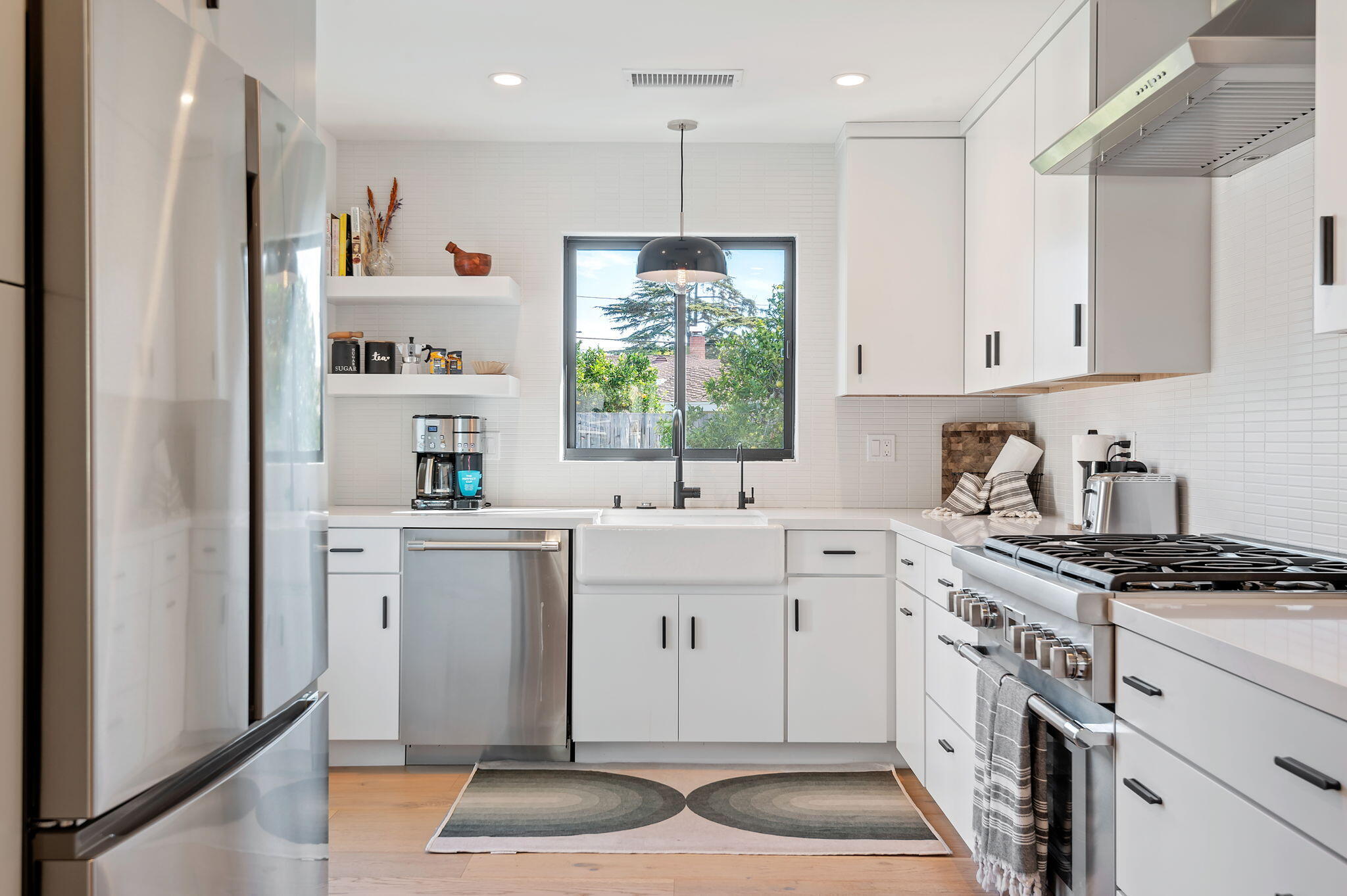 308 Cooper Road Santa Barbara, CA 93109 - Photo 18 of 41 a kitchen with white cabinets and window