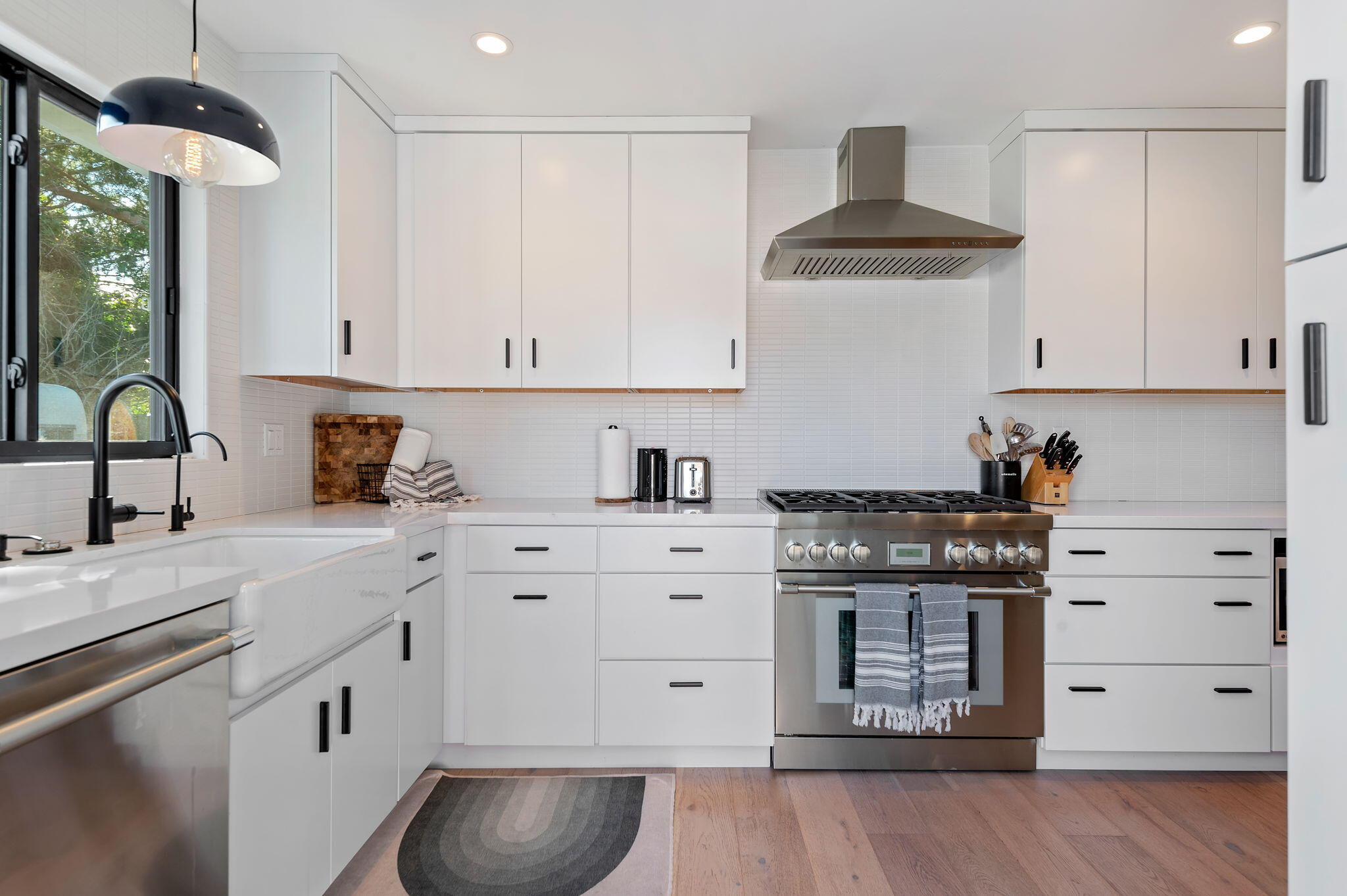 308 Cooper Road Santa Barbara, CA 93109 - Photo 6 of 41 a kitchen with stainless steel appliances granite countertop a stove and white cabinets