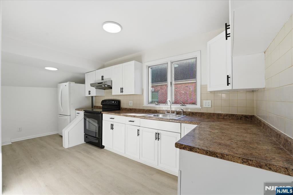 85 Beckwith Place Rutherford, NJ 07070 - Photo 20 of 49 a kitchen with granite countertop a sink stove and cabinets