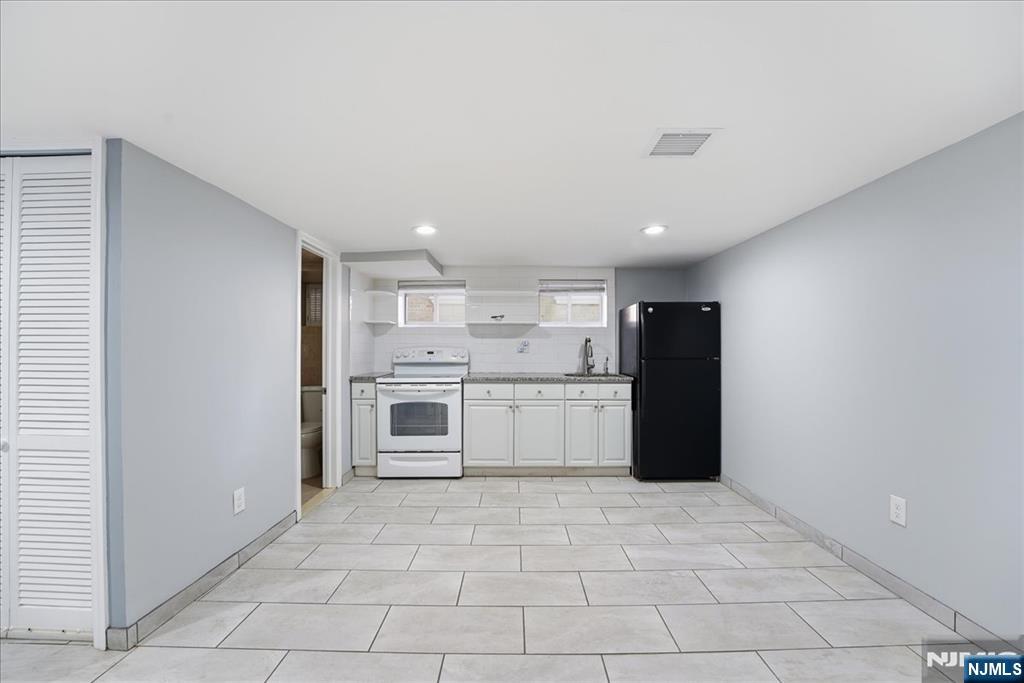 85 Beckwith Place Rutherford, NJ 07070 - Photo 36 of 49 a large white kitchen with a stove a refrigerator and a sink