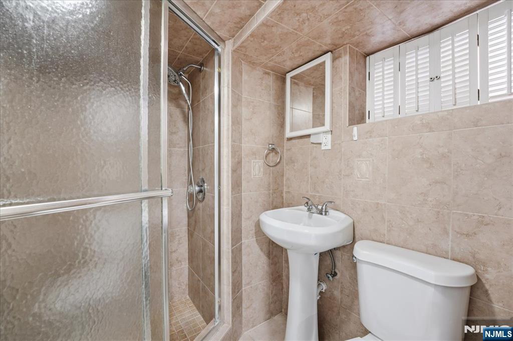 85 Beckwith Place Rutherford, NJ 07070 - Photo 38 of 49 a bathroom with a sink toilet and a mirror