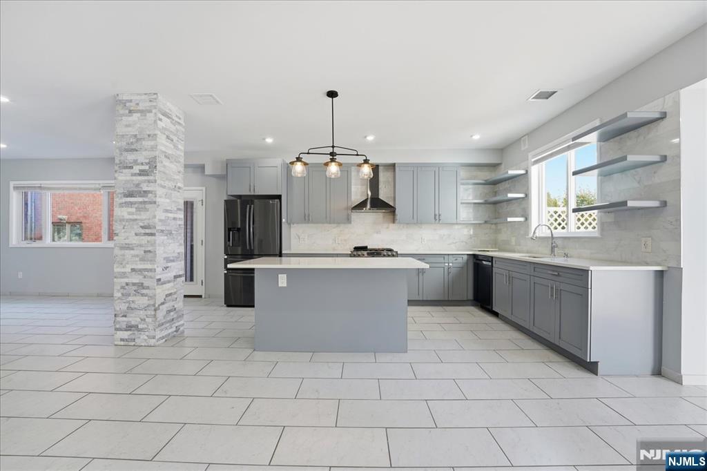 85 Beckwith Place Rutherford, NJ 07070 - Photo 5 of 49 a large kitchen with kitchen island granite countertop a stove a sink a counter top space and cabinets