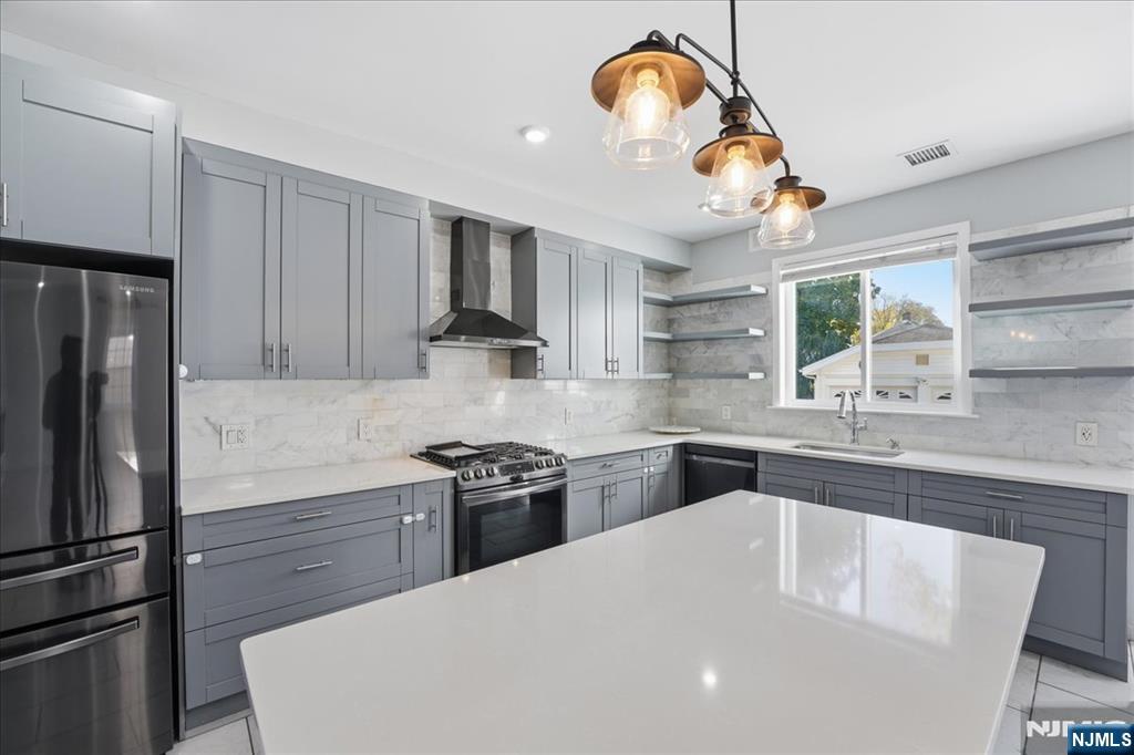85 Beckwith Place Rutherford, NJ 07070 - Photo 6 of 49 a kitchen with stainless steel appliances granite countertop a sink a stove and refrigerator