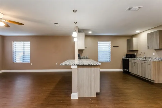 a view of backyard with swimming pool and seating space