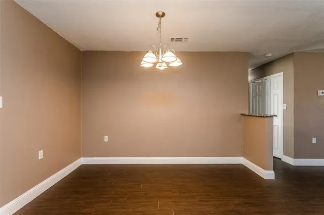 a kitchen with stainless steel appliances granite countertop a sink cabinets and wooden floor