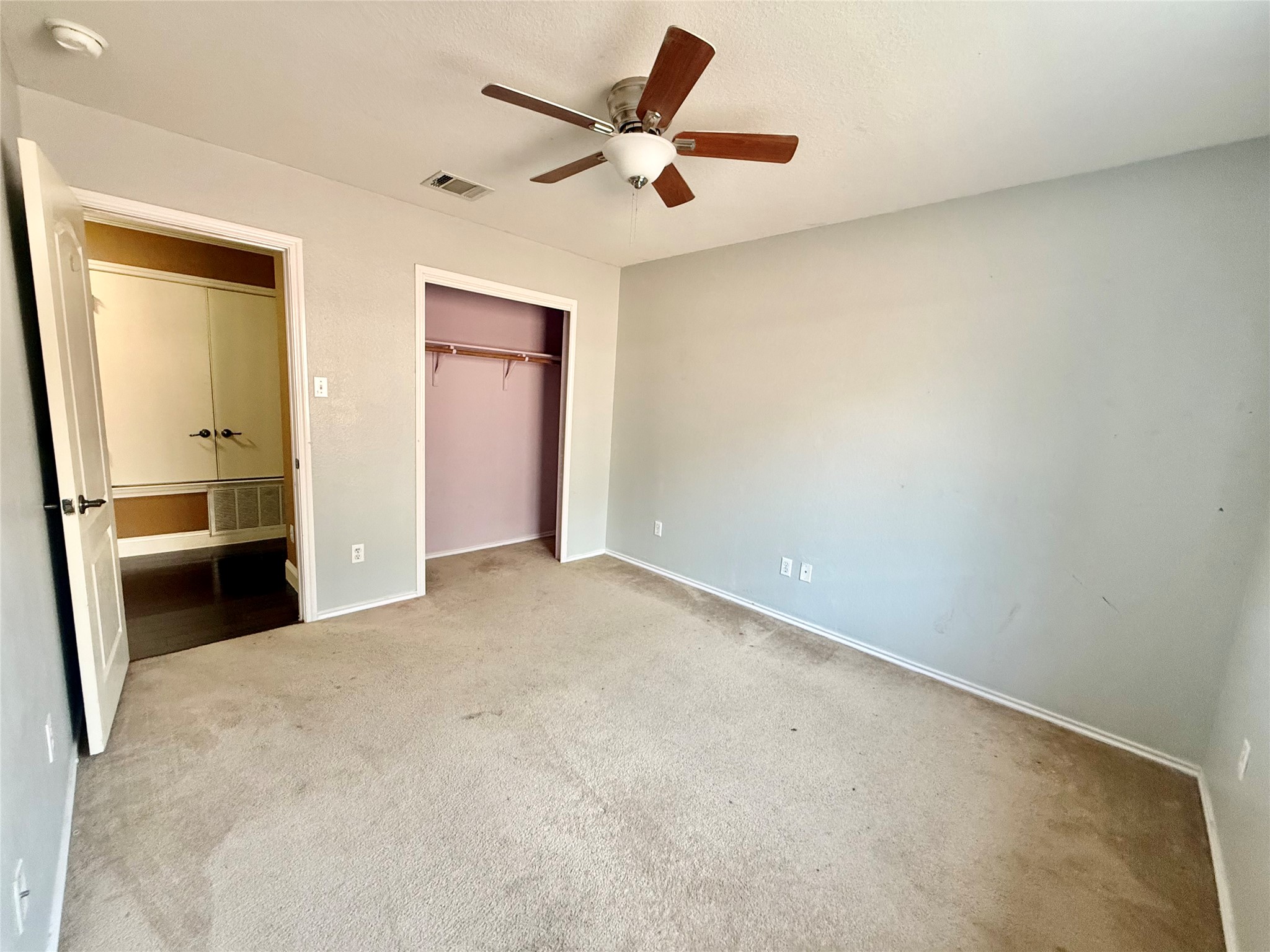 12820 Waynespur Lane Elgin, TX 78621 - Photo 22 of 26 Unfurnished bedroom with carpet floors, a closet, and ceiling fan