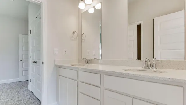 a bathroom with a double vanity sink and a mirror
