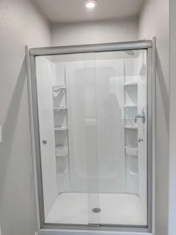 a bathroom with a glass shower door