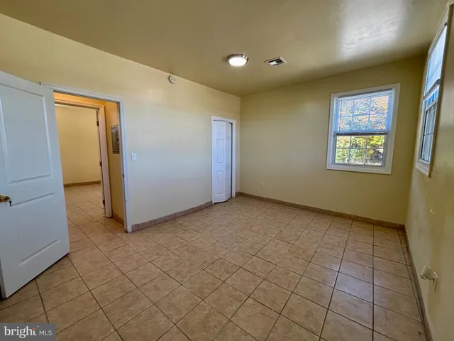 a view of an empty room and a window