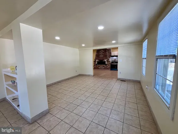 a view of a livingroom with furniture and an empty room