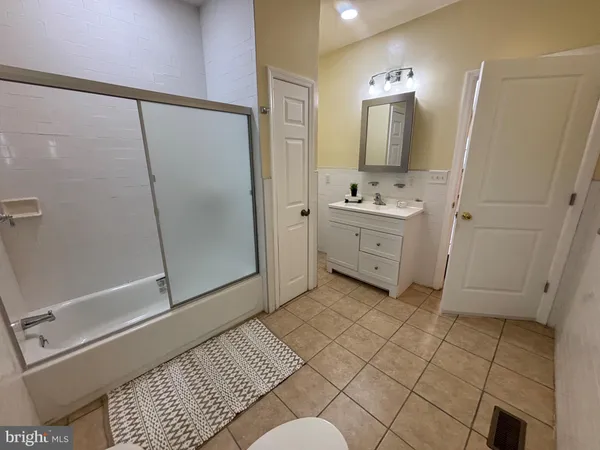 a bathroom with a sink a mirror and a shower