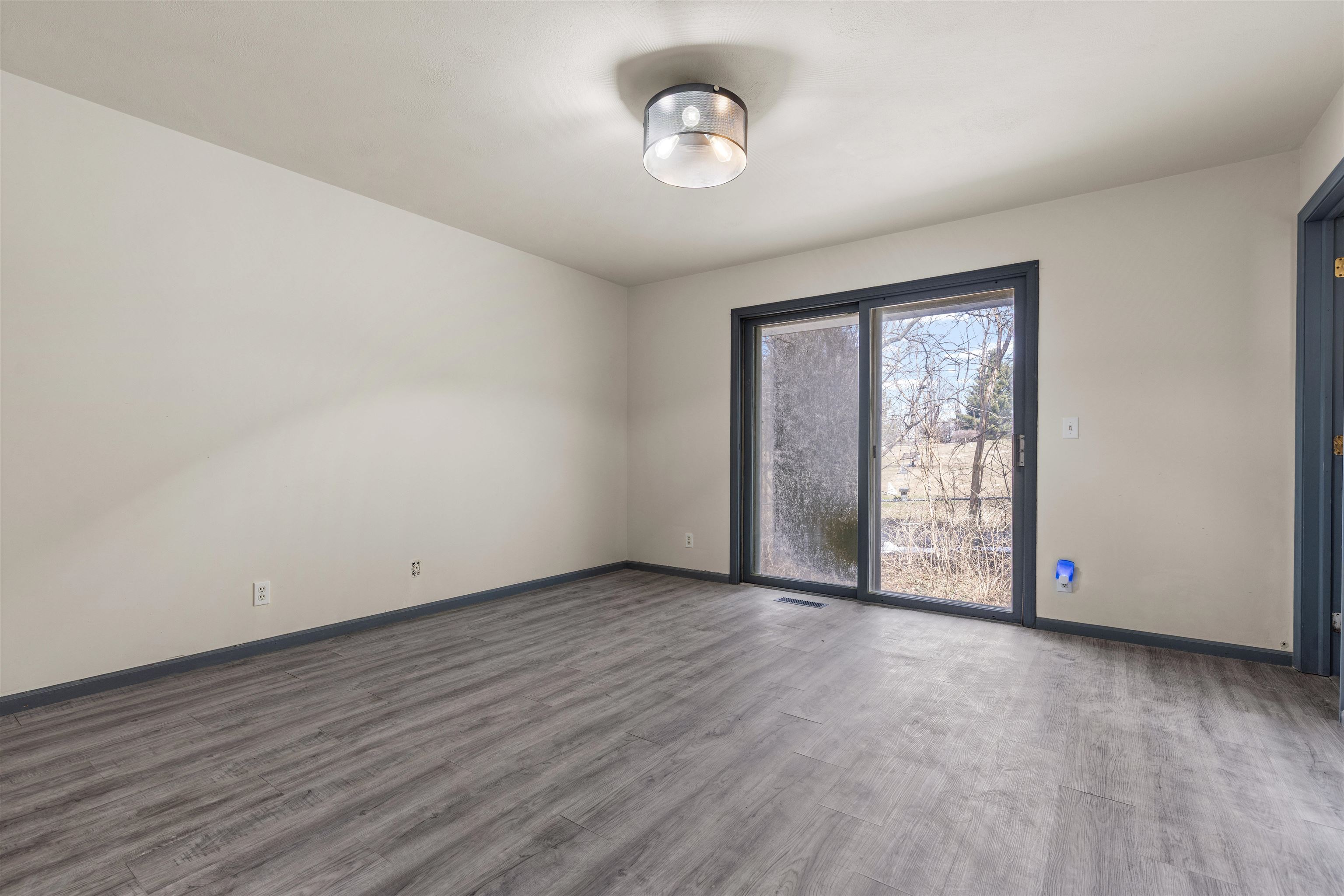 7010 Prairie Hill Road South Beloit, IL 61080 - Photo 11 of 21 a view of an empty room with wooden floor and a window