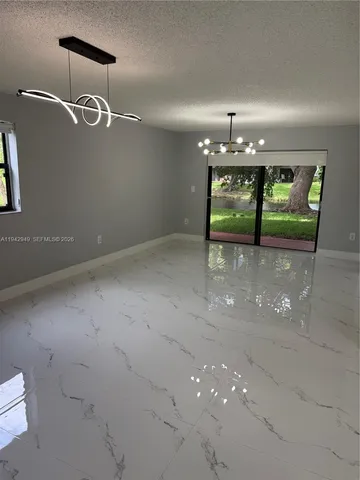 a large white kitchen with a refrigerator a stove and a sink